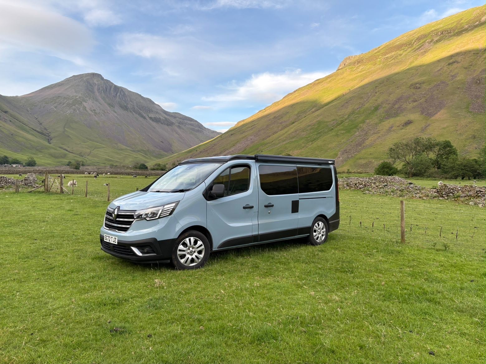Maisie-Moo parked in a Lake District valley with sunlit fells behind