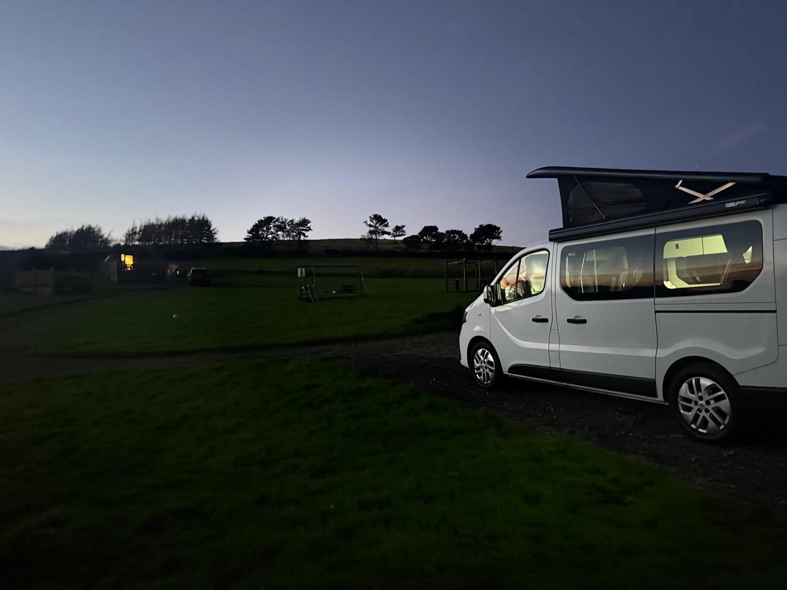 Lulu campervan on a campsite at twilight