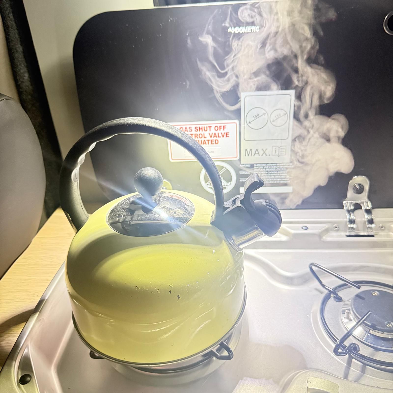 Kettle steaming on the campervan hob