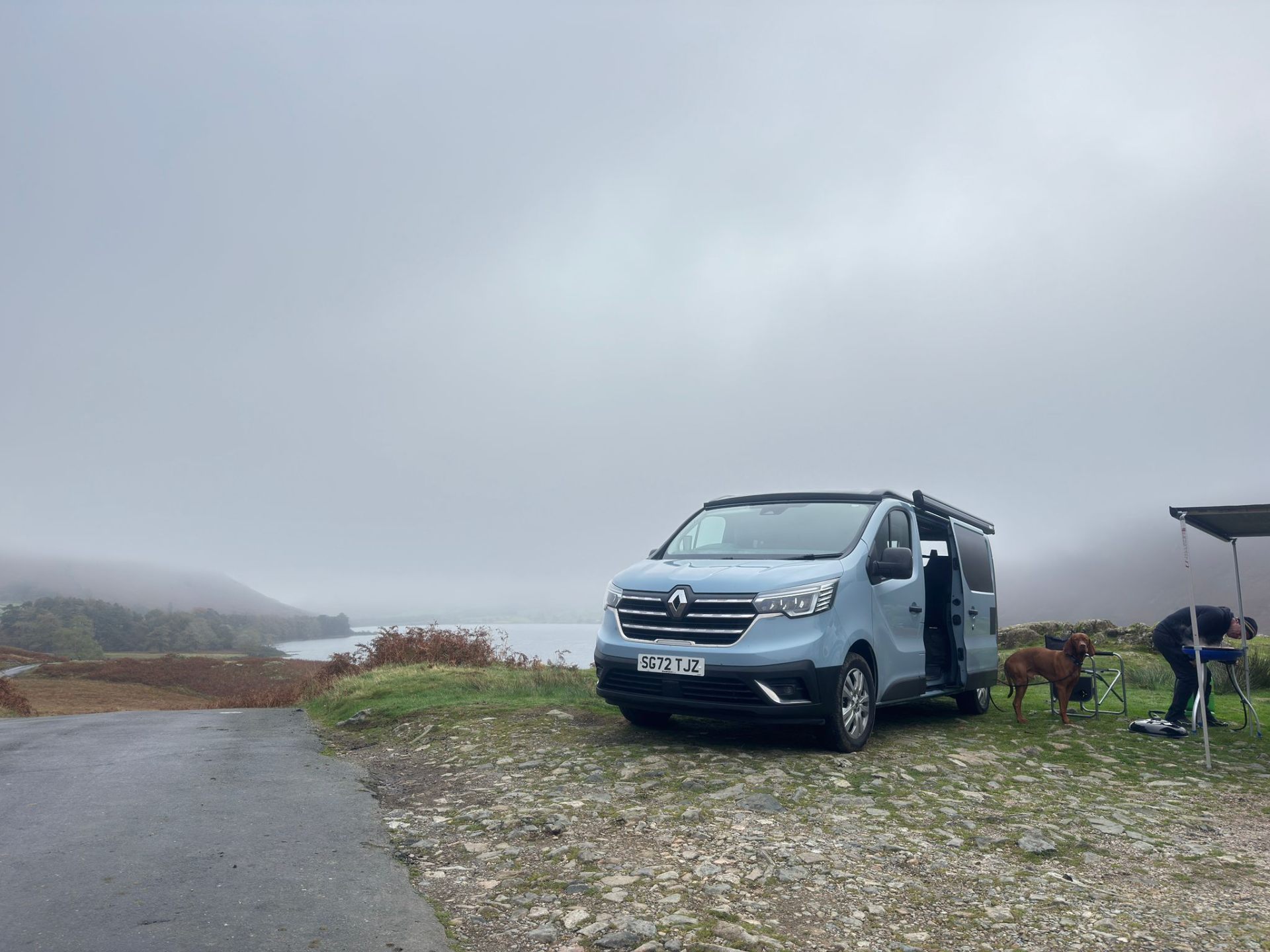 Maisie-Moo parked by a Lake District lake with a dog